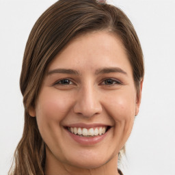 Joyful white young-adult female with long  brown hair and grey eyes