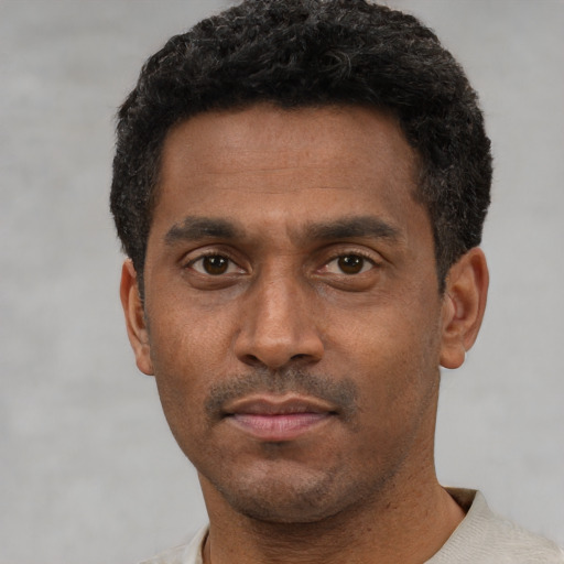 Neutral latino adult male with short  black hair and brown eyes