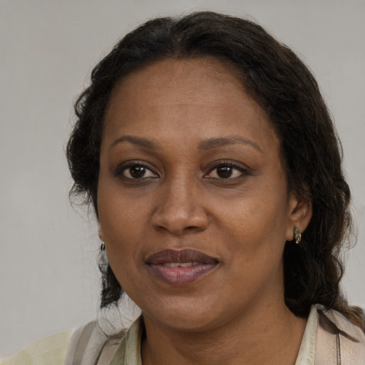 Joyful black adult female with medium  brown hair and brown eyes
