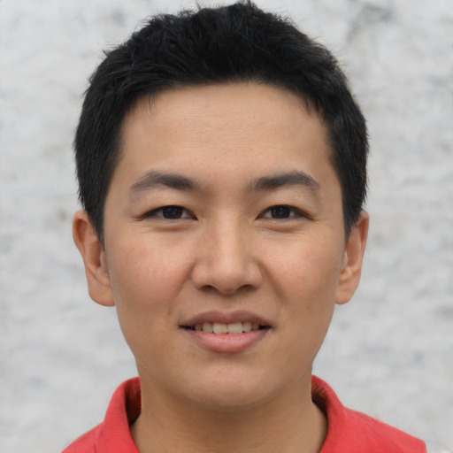 Joyful asian young-adult male with short  brown hair and brown eyes