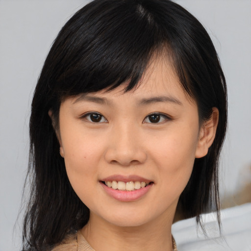 Joyful asian young-adult female with medium  brown hair and brown eyes