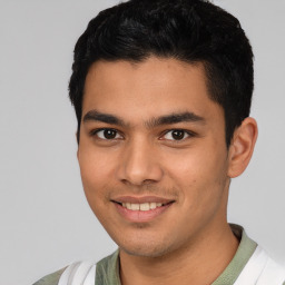 Joyful white young-adult male with short  black hair and brown eyes