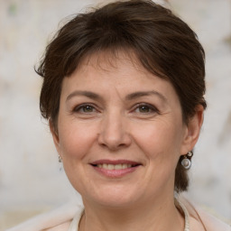 Joyful white adult female with medium  brown hair and brown eyes