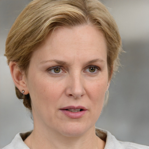 Joyful white adult female with medium  brown hair and blue eyes