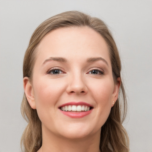 Joyful white young-adult female with long  brown hair and grey eyes