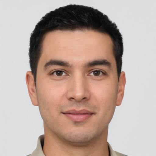 Joyful white young-adult male with short  black hair and brown eyes