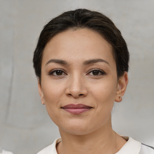 Joyful white young-adult female with short  brown hair and brown eyes