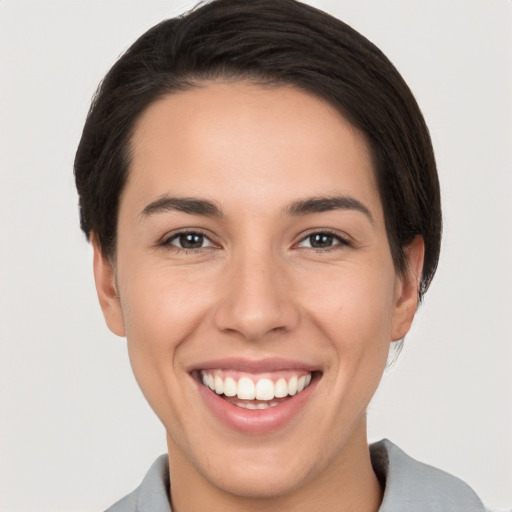 Joyful white young-adult female with short  brown hair and brown eyes