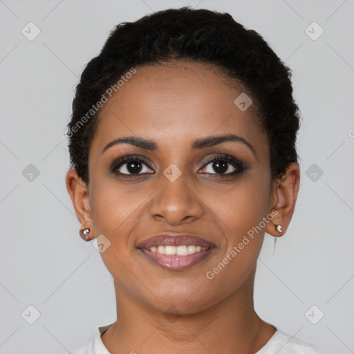 Joyful black young-adult female with short  black hair and brown eyes