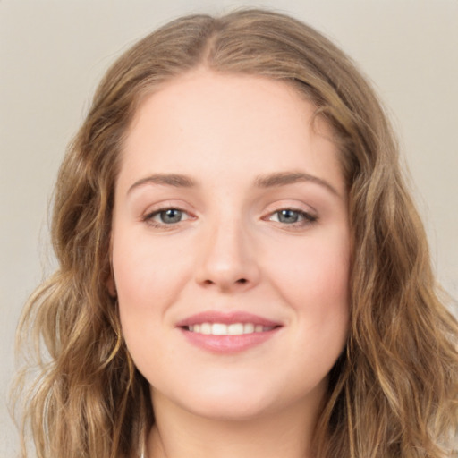 Joyful white young-adult female with long  brown hair and green eyes