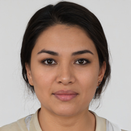 Joyful latino young-adult female with medium  brown hair and brown eyes