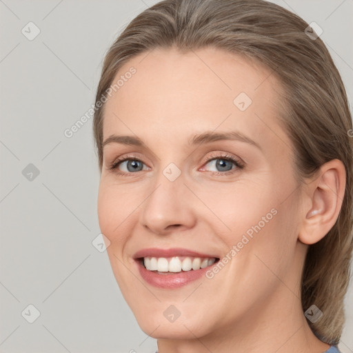 Joyful white young-adult female with medium  brown hair and grey eyes