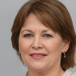 Joyful white adult female with medium  brown hair and grey eyes