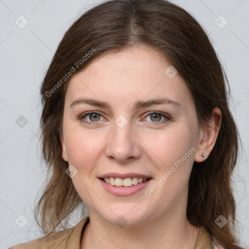 Joyful white young-adult female with medium  brown hair and grey eyes