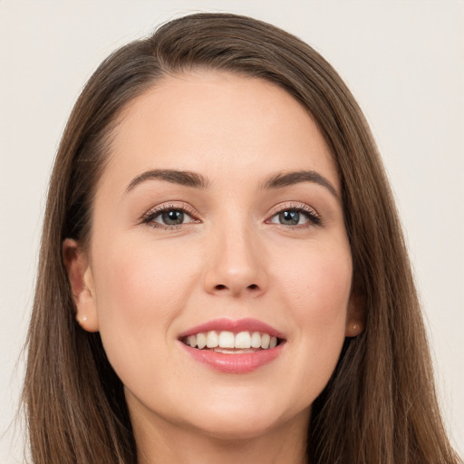 Joyful white young-adult female with long  brown hair and grey eyes