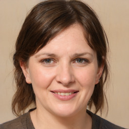 Joyful white adult female with medium  brown hair and grey eyes