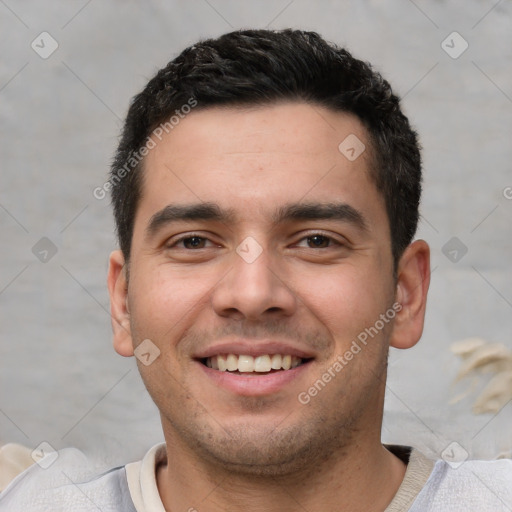 Joyful white young-adult male with short  black hair and brown eyes