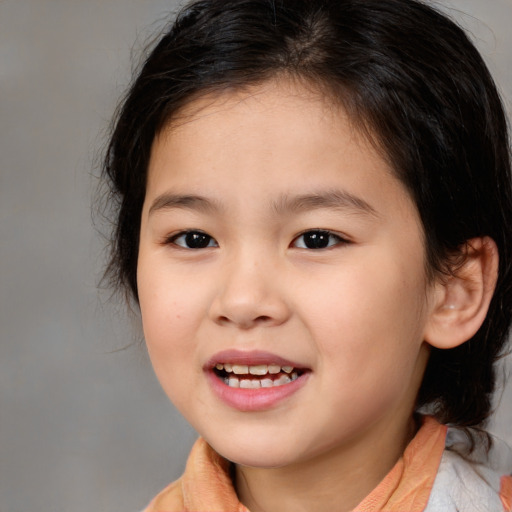 Joyful white child female with medium  brown hair and brown eyes