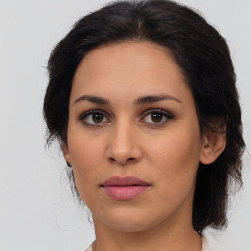 Joyful latino young-adult female with medium  brown hair and brown eyes