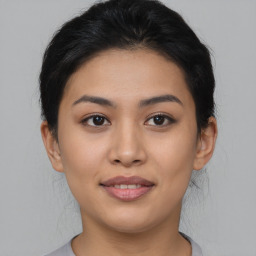 Joyful asian young-adult female with medium  brown hair and brown eyes