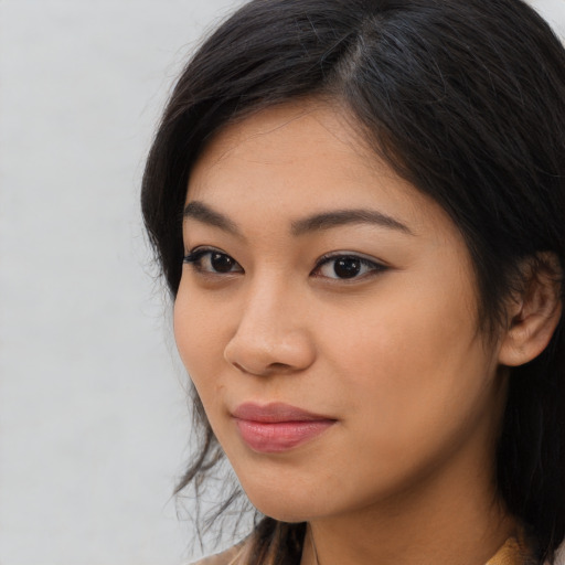 Joyful asian young-adult female with medium  black hair and brown eyes