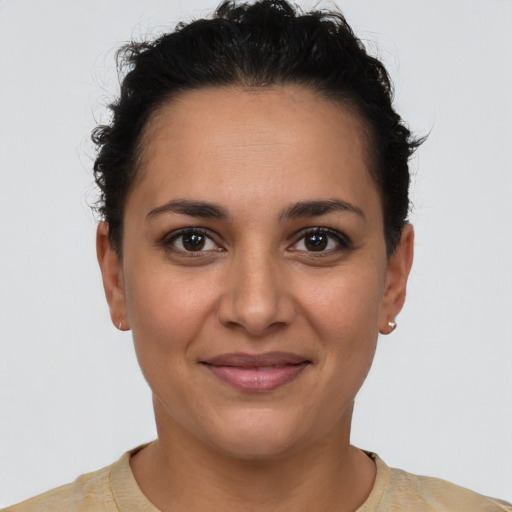 Joyful latino young-adult female with short  brown hair and brown eyes