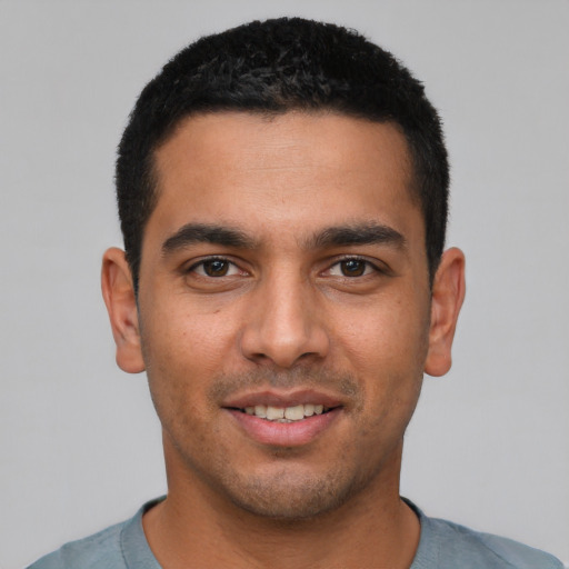 Joyful white young-adult male with short  black hair and brown eyes