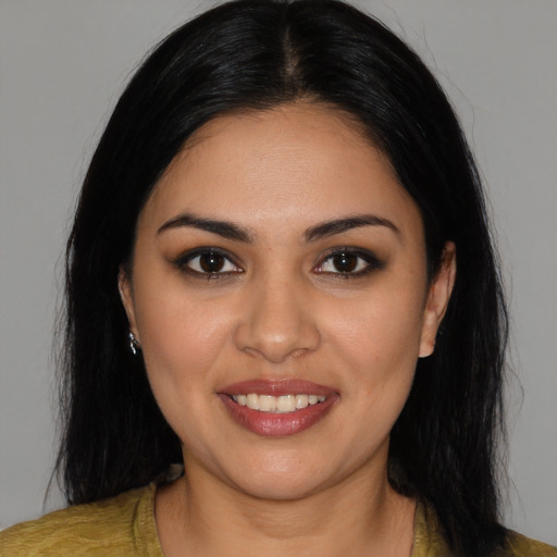 Joyful latino young-adult female with medium  black hair and brown eyes