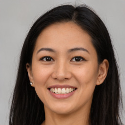 Joyful asian young-adult female with long  brown hair and brown eyes