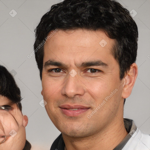 Joyful white adult male with short  black hair and brown eyes