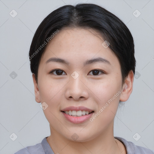 Joyful asian young-adult female with short  black hair and brown eyes