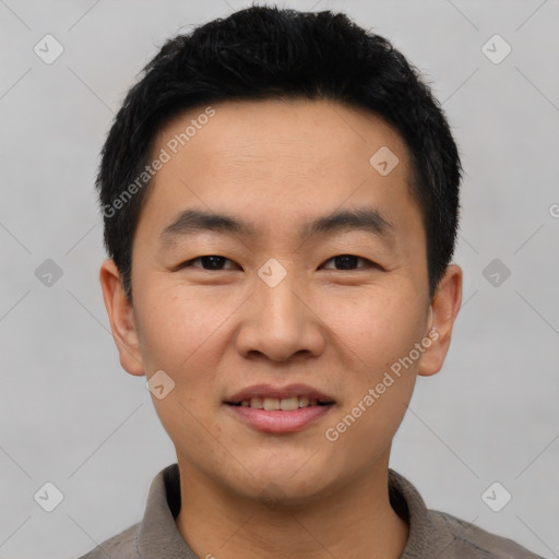 Joyful asian young-adult male with short  black hair and brown eyes