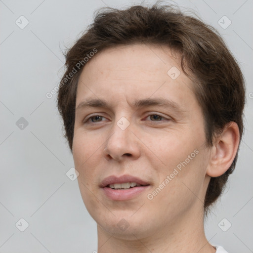 Joyful white adult male with short  brown hair and brown eyes