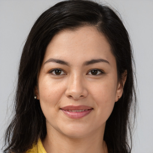 Joyful latino young-adult female with long  brown hair and brown eyes