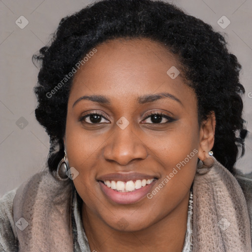 Joyful black young-adult female with long  black hair and brown eyes