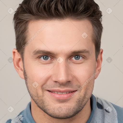 Joyful white young-adult male with short  brown hair and grey eyes