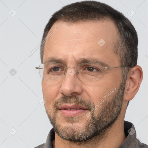 Joyful white adult male with short  black hair and brown eyes