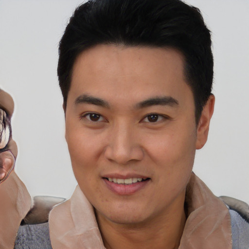 Joyful white young-adult male with short  black hair and brown eyes