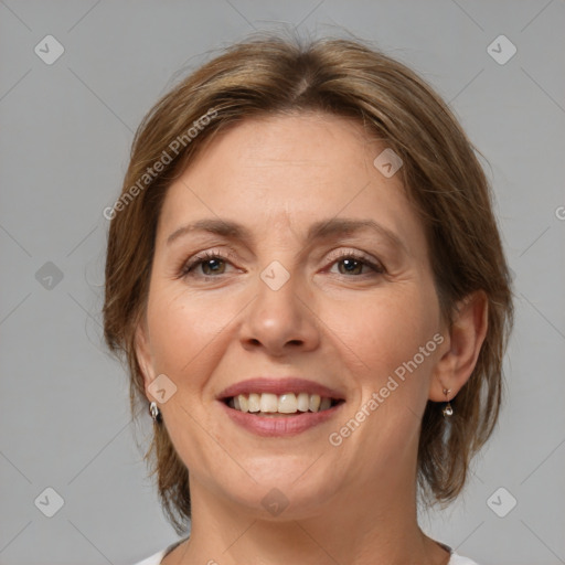 Joyful white adult female with medium  brown hair and brown eyes