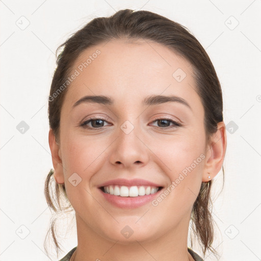 Joyful white young-adult female with long  brown hair and grey eyes