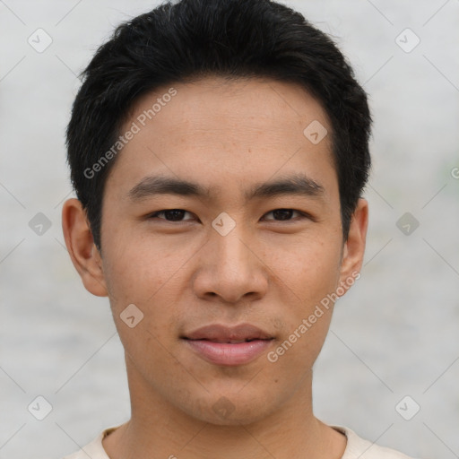 Joyful asian young-adult male with short  black hair and brown eyes