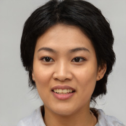 Joyful asian young-adult female with medium  black hair and brown eyes