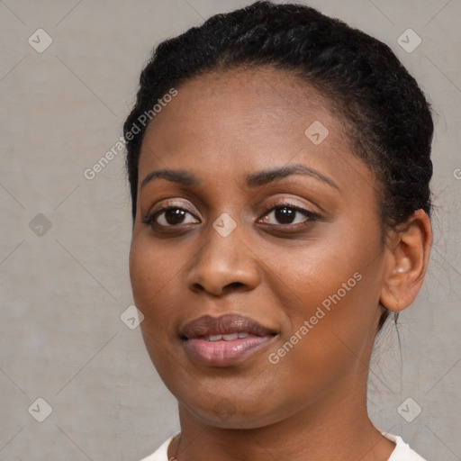 Joyful black young-adult female with short  brown hair and brown eyes