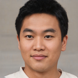 Joyful asian young-adult male with short  black hair and brown eyes