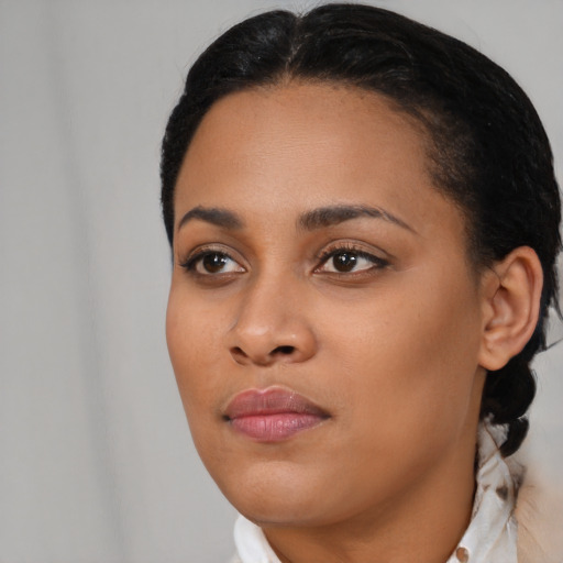 Neutral black young-adult female with medium  black hair and brown eyes