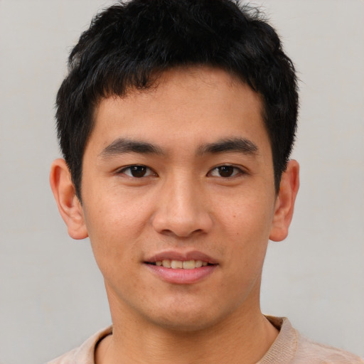 Joyful asian young-adult male with short  black hair and brown eyes