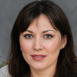 Joyful white adult female with medium  brown hair and brown eyes