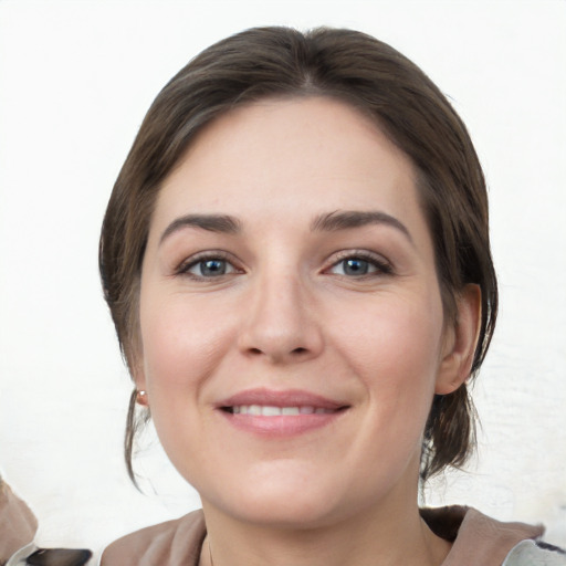 Joyful white young-adult female with medium  brown hair and grey eyes