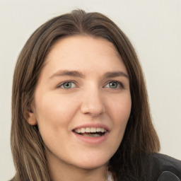 Joyful white young-adult female with long  brown hair and green eyes