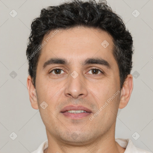 Joyful white young-adult male with short  black hair and brown eyes